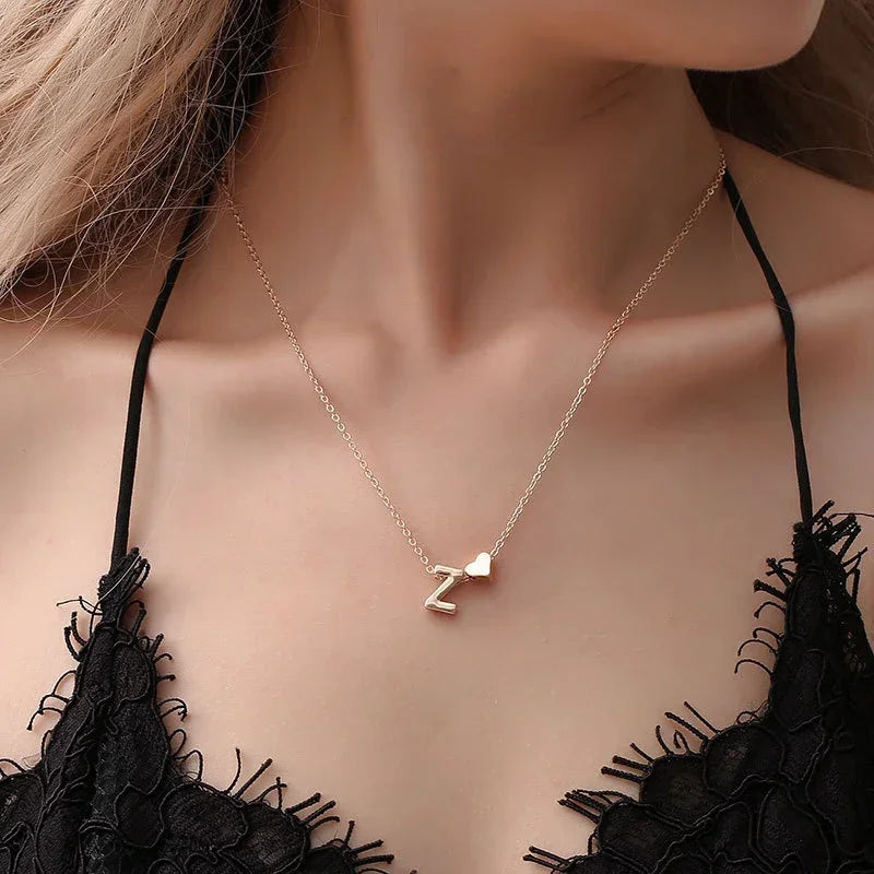Women's necklace collection at Varex HQ — dainty heart and initial pendant necklaces in gold and silver