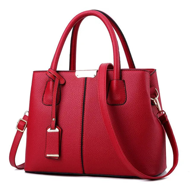 Women's handbag collection at Varex HQ — structured red pebbled PU leather satchel tote