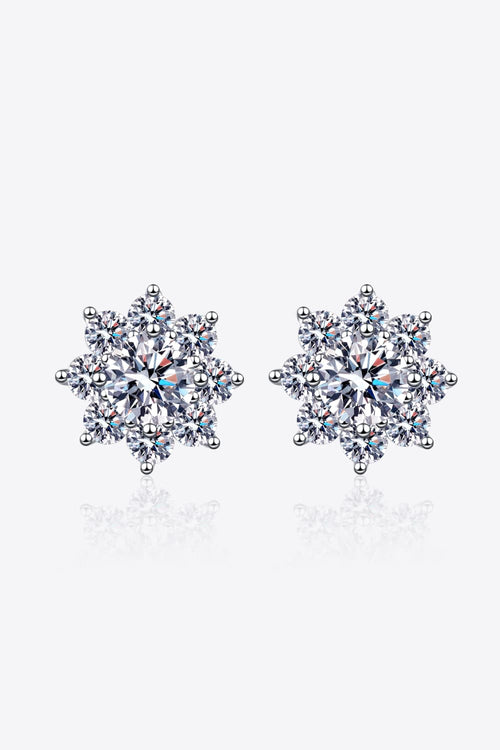1 carat moissanite flower stud earrings in 925 sterling silver on white reflection surface.