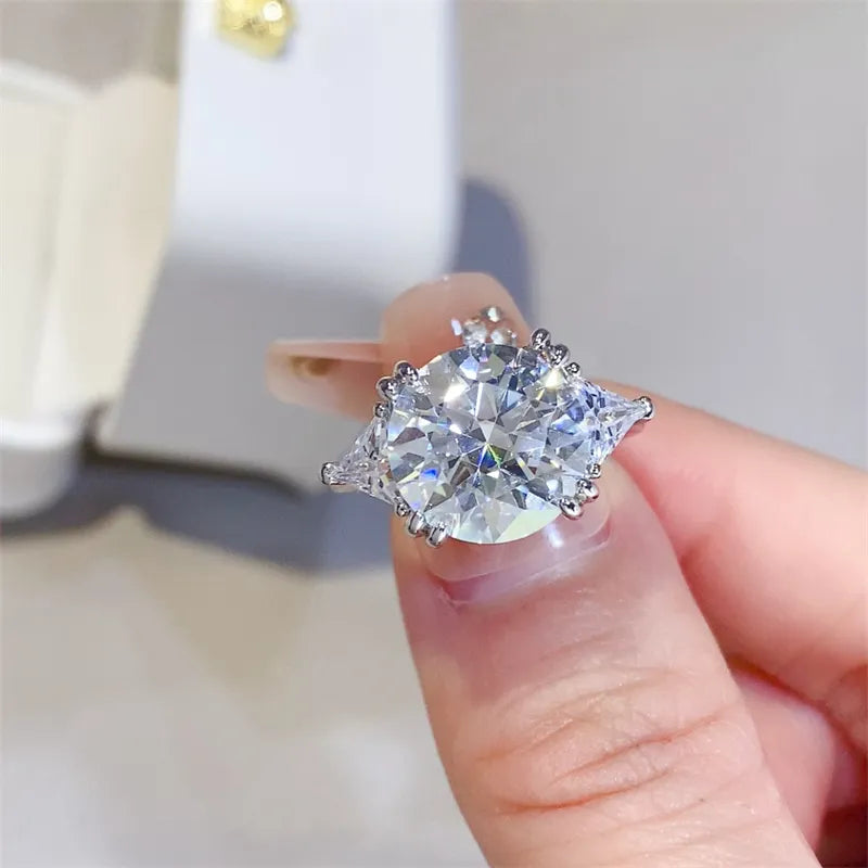 Extreme close-up of 5 carat brilliant round cut moissanite center stone held in hand.
