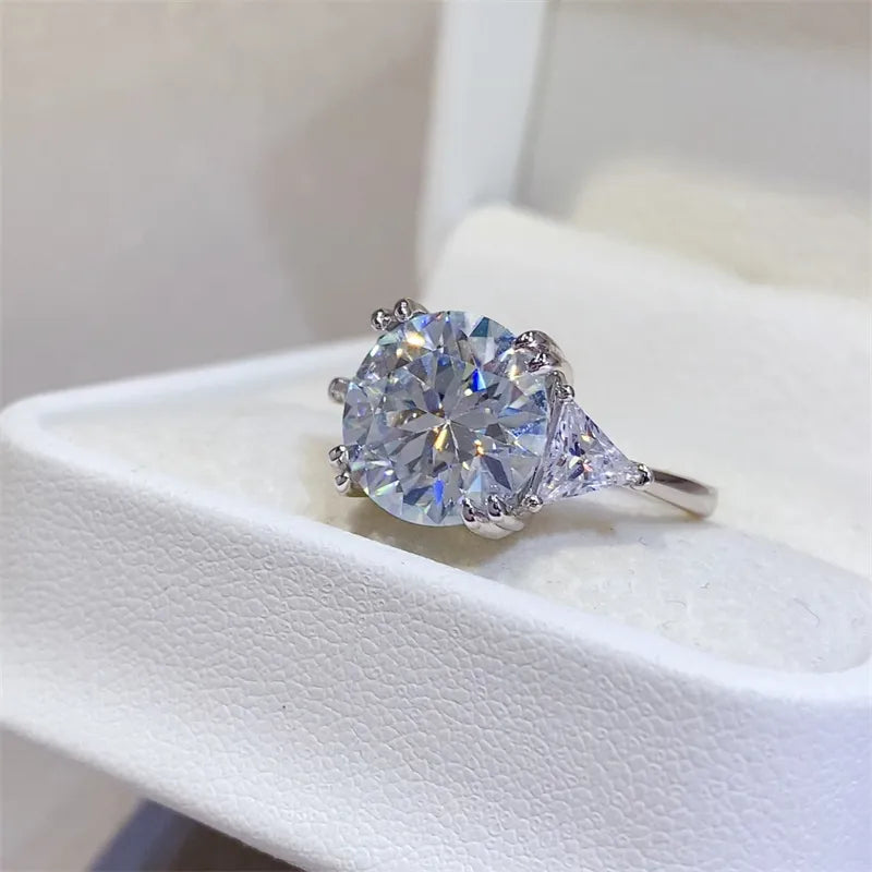 Side angle view highlighting sparkling faceting of 5 carat moissanite ring in white cushion box.