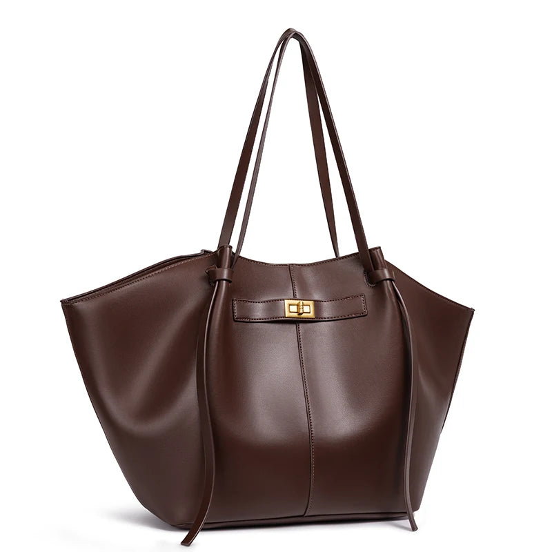 Brown bat-shaped vegan leather shoulder bag - front view showing statement silhouette