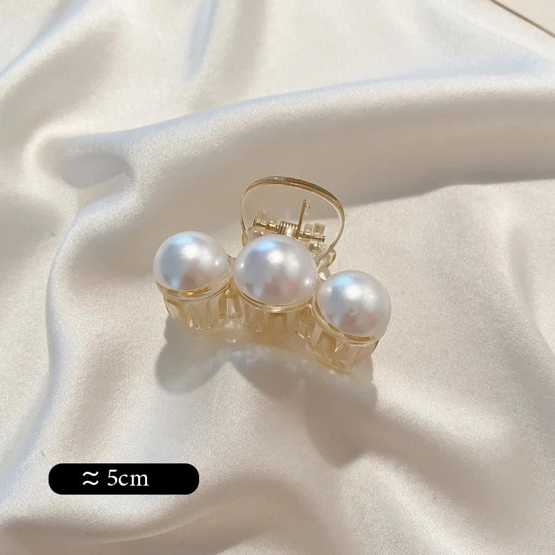 Big Pearl Hair Claw Clip in alloy with faux pearl accents, in hand for scale - Varex HQ