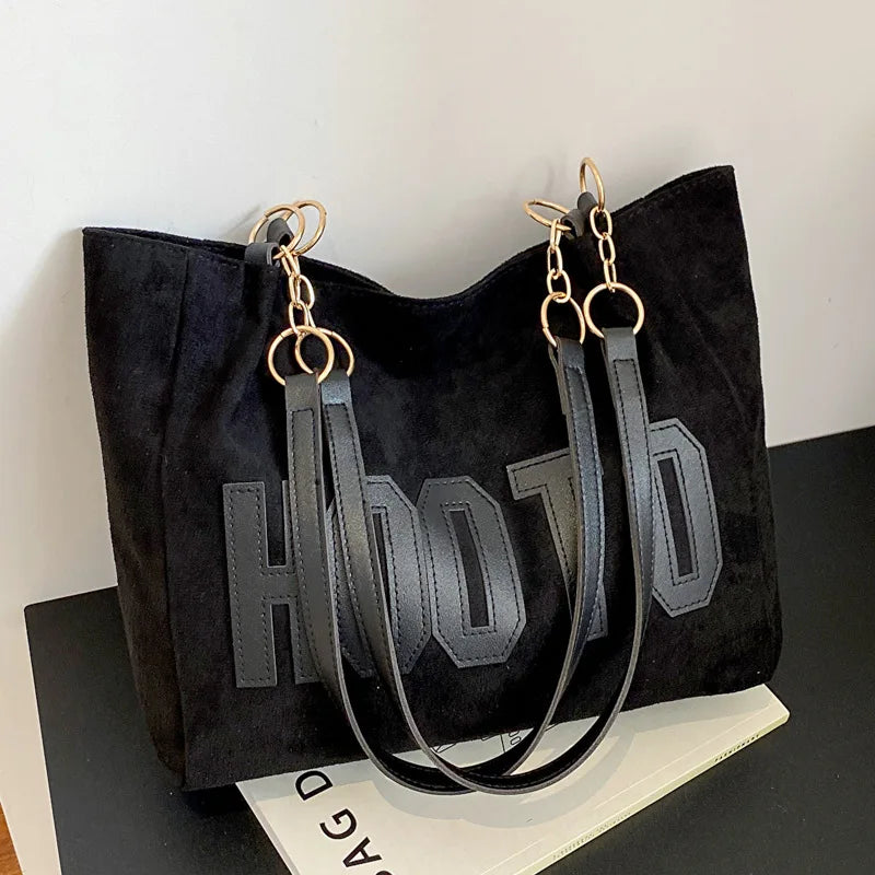 Black canvas campus tote bag - close-up of letter-print detailing