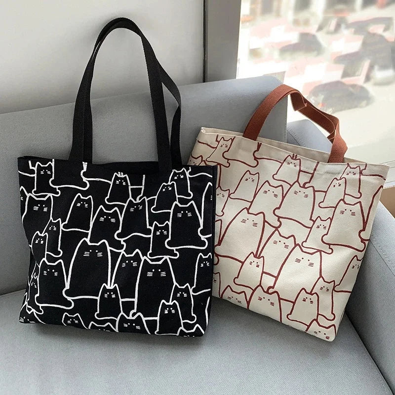 Beige cat-print canvas tote bag - front view showing cartoon-style cat design