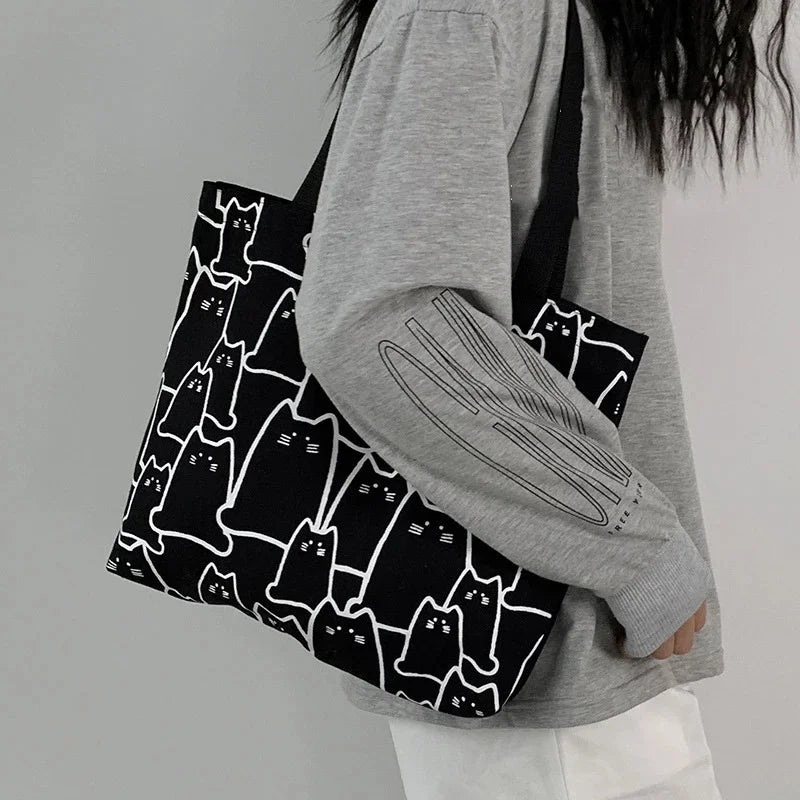 Beige cat-print canvas tote bag - lifestyle shot worn on the shoulder