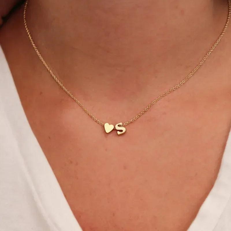 Dainty heart and initial pendant necklace in gold-tone alloy - lifestyle gifting shot - Varex HQ