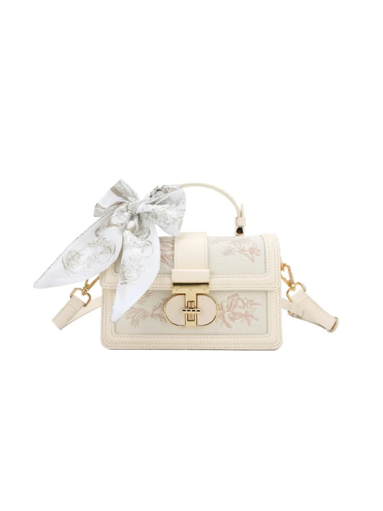 Beige vegan leather shoulder bag - front view showing scarf and charm detailing