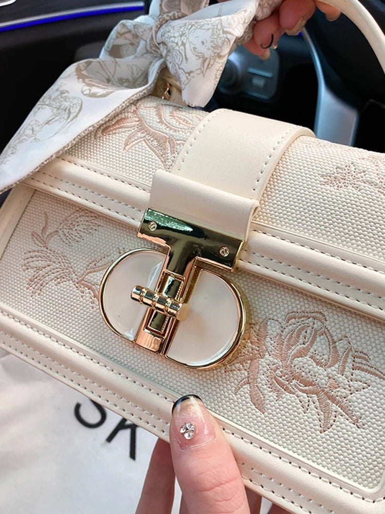 Beige vegan leather shoulder bag - close-up of decorative scarf and charm detail