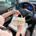 Beige vegan leather shoulder bag - side angle showing structured silhouette