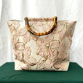 Pink embroidered canvas tote bag - lifestyle shot carried by hand