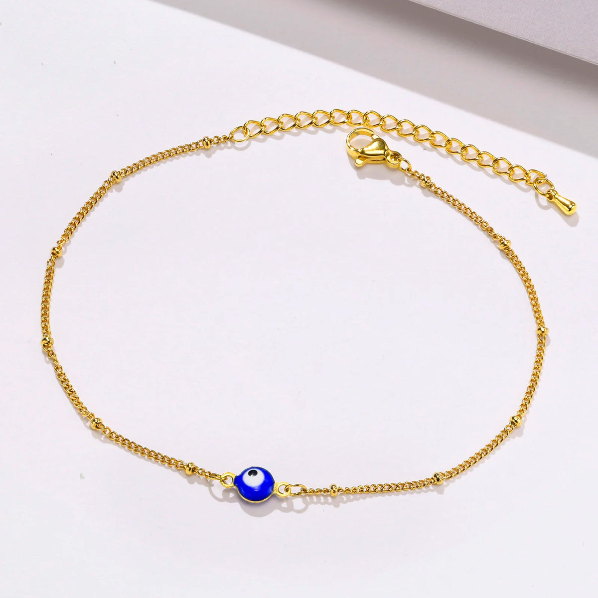 Evil eye beaded anklet, flat lay product shot, Varex HQ