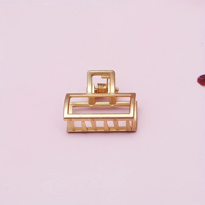 Geometric Hollow Hair Claw Clip in gold-tone metal finish, worn in hair - Varex HQ