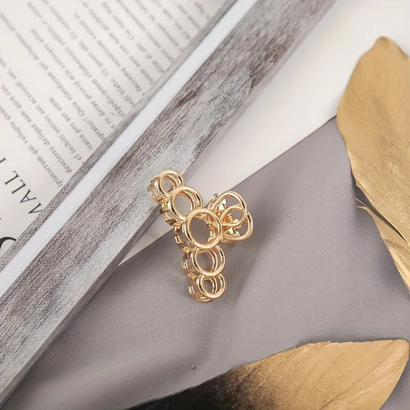 Geometric Hollow Hair Claw Clip in gold-tone metal finish, close-up detail - Varex HQ