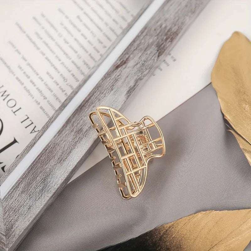 Geometric Hollow Hair Claw Clip in gold-tone metal finish, lifestyle shot - Varex HQ