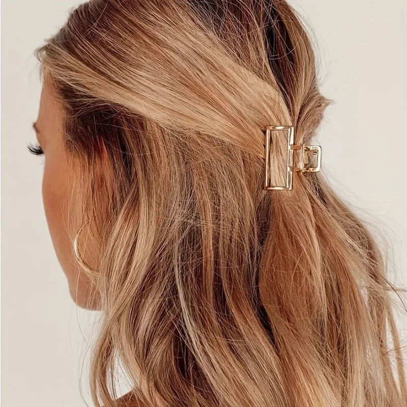 Geometric Hollow Hair Claw Clip in gold-tone metal finish, styling angle - Varex HQ