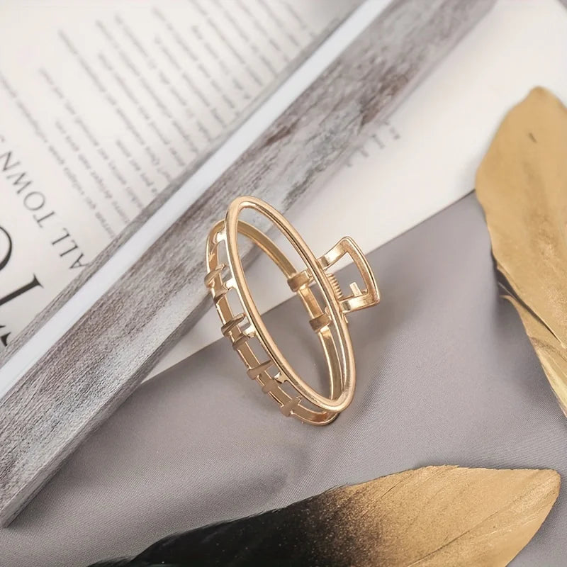 Geometric Hollow Hair Claw Clip in gold-tone metal finish, lifestyle shot - Varex HQ