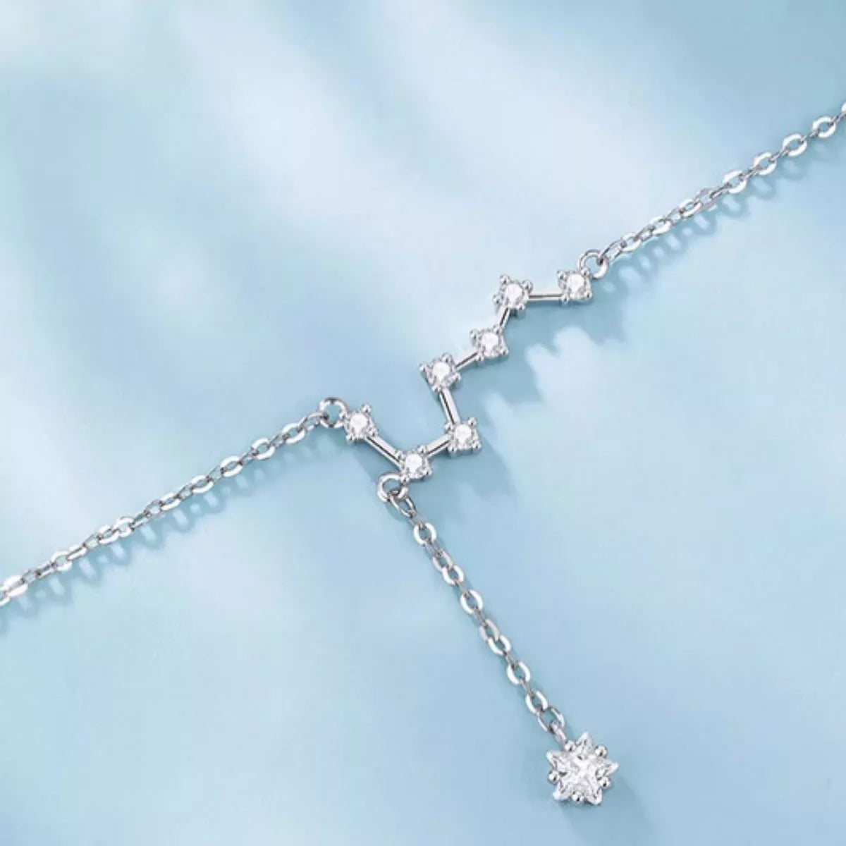 Dangling star drop detail on zircon silver-tone anklet, Varex HQ