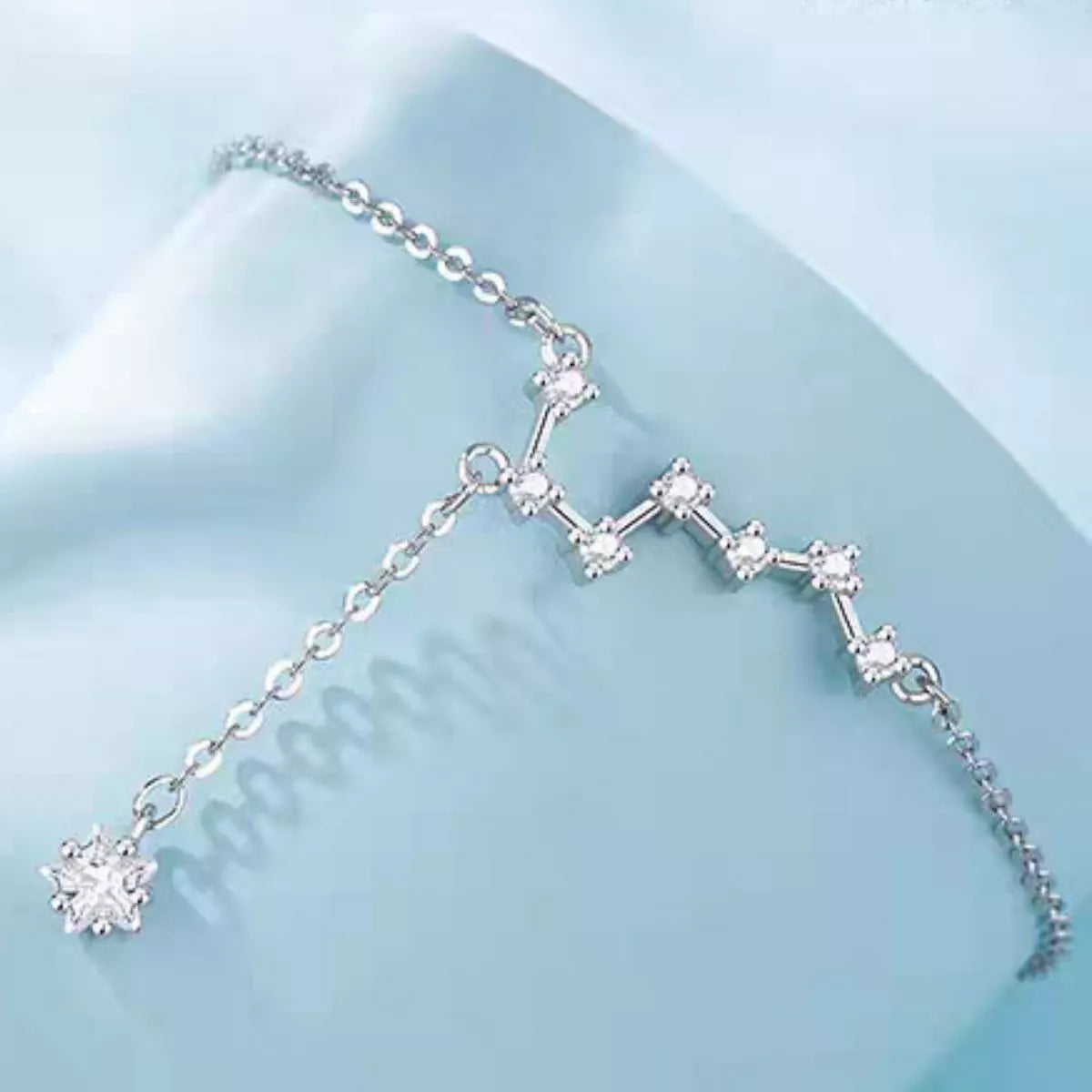 Close-up of silver-tone zircon constellation chain link, Varex HQ
