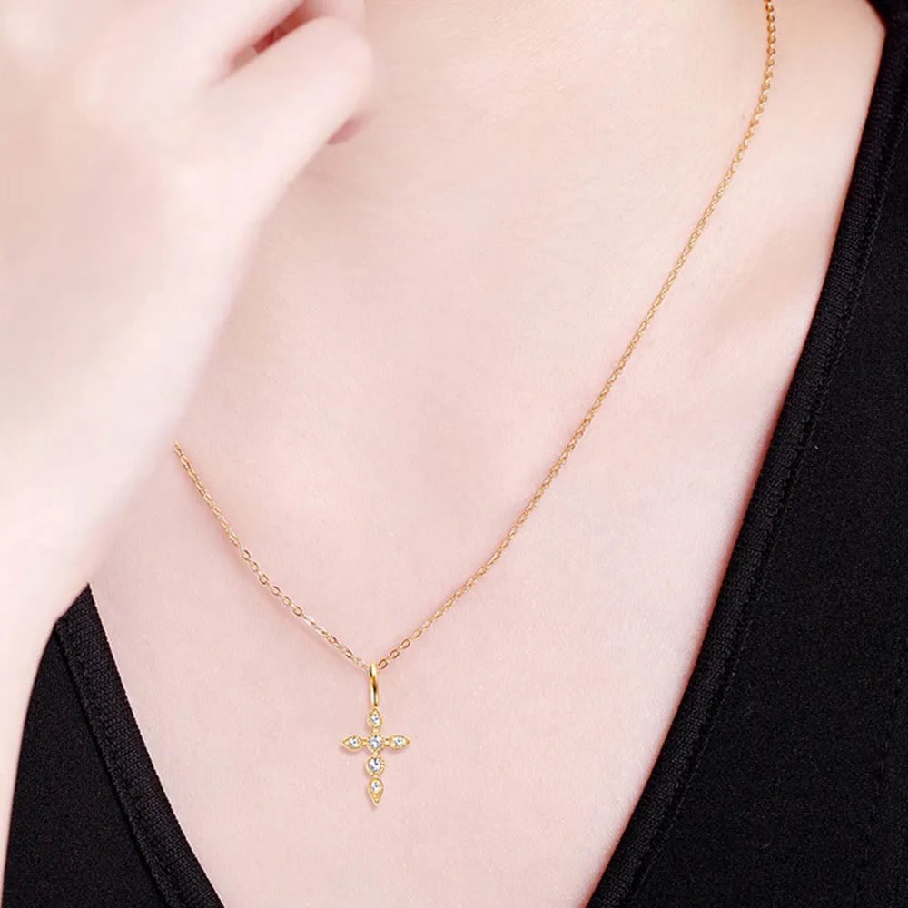 Model wearing 18K gold-plated moissanite cross pendant necklace.