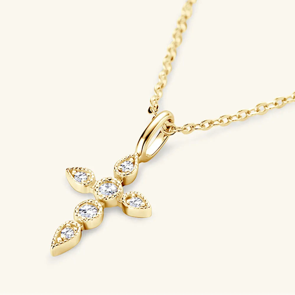 Close-up of 18K gold-plated moissanite cross pendant showing D-color gemstones.
