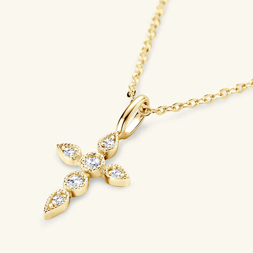 Close-up of 18K gold-plated moissanite cross pendant showing D-color gemstones.