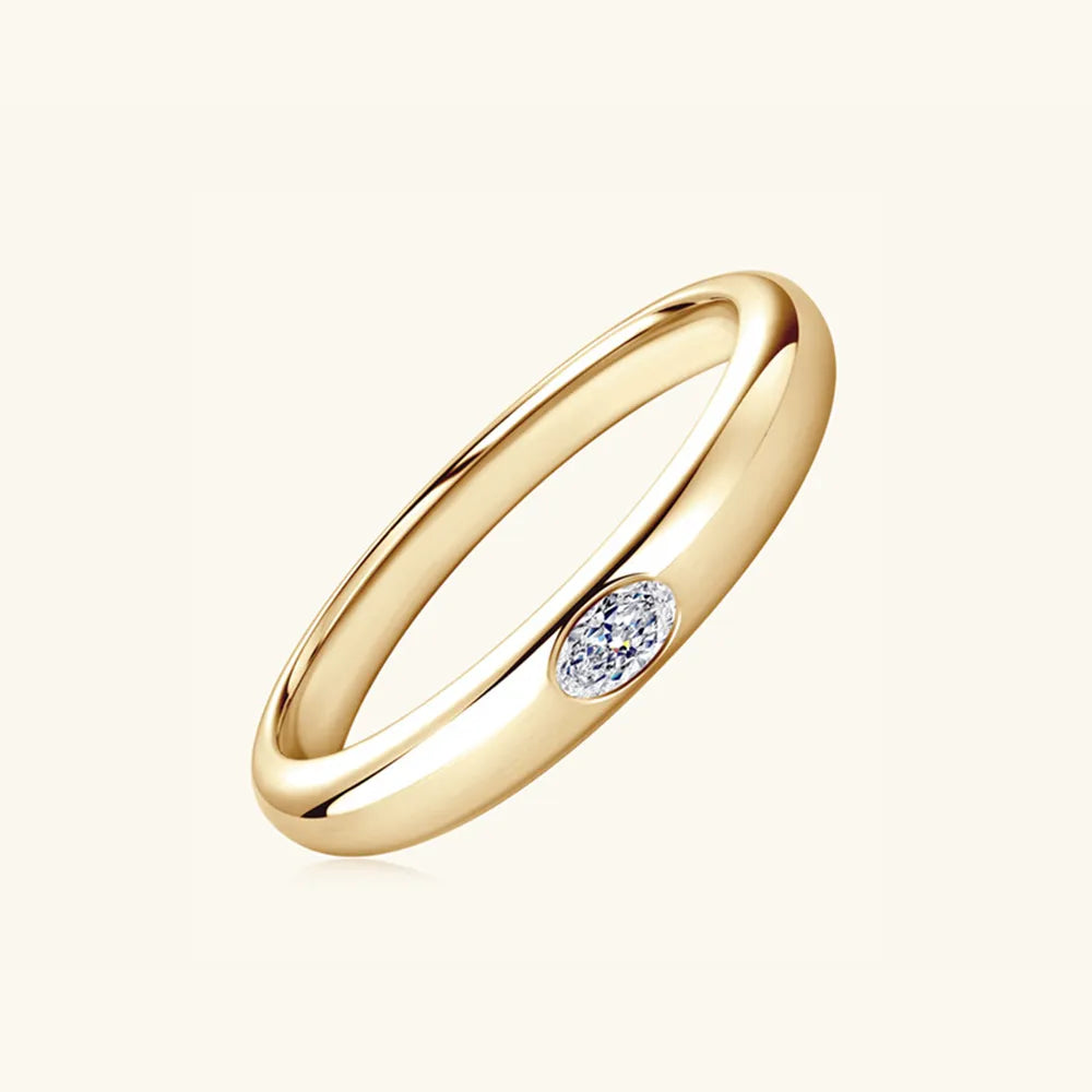 Angled view of gold-plated silver ring showcasing flush-set moissanite stone.