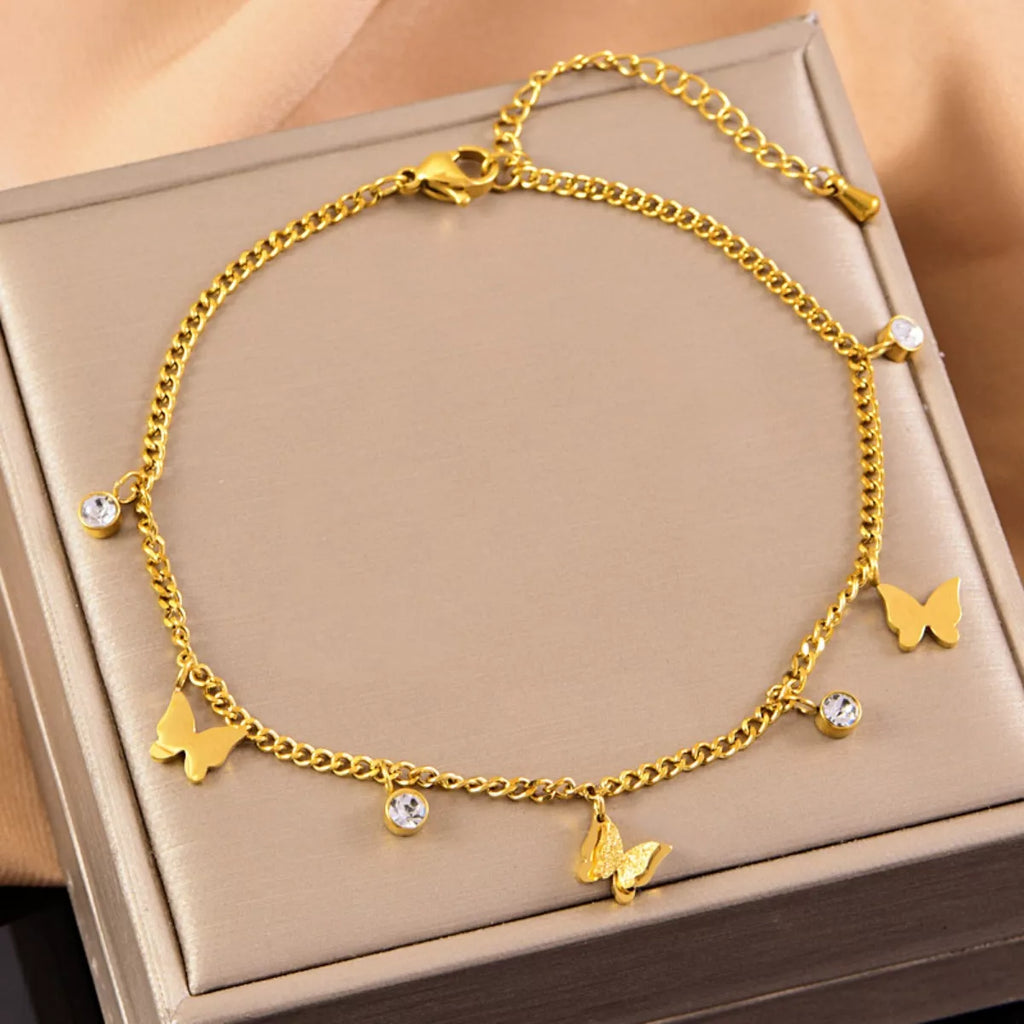 Gold-plated butterfly anklet displayed on a luxury jewelry box