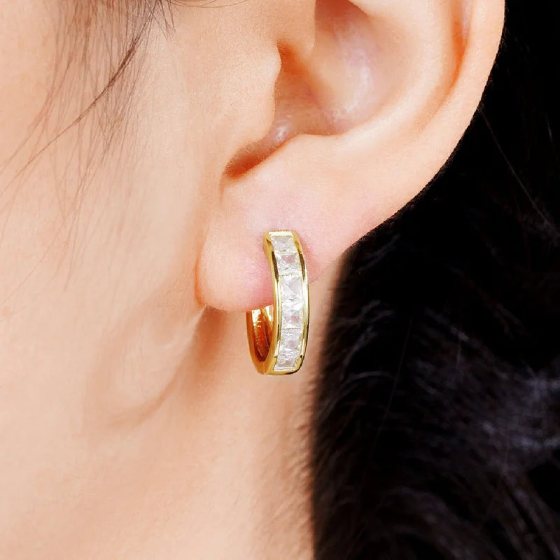 Gold-plated stainless steel round hoop earrings with cubic zirconia, worn on model, close-up - Varex HQ