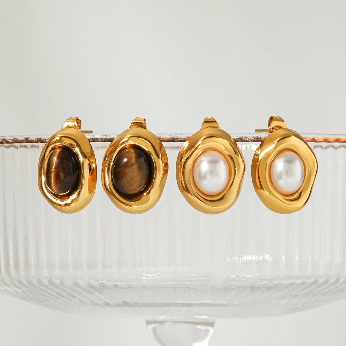 Gold-plated stud earrings with stone and faux-pearl accent, styling angle 2 - Varex HQ