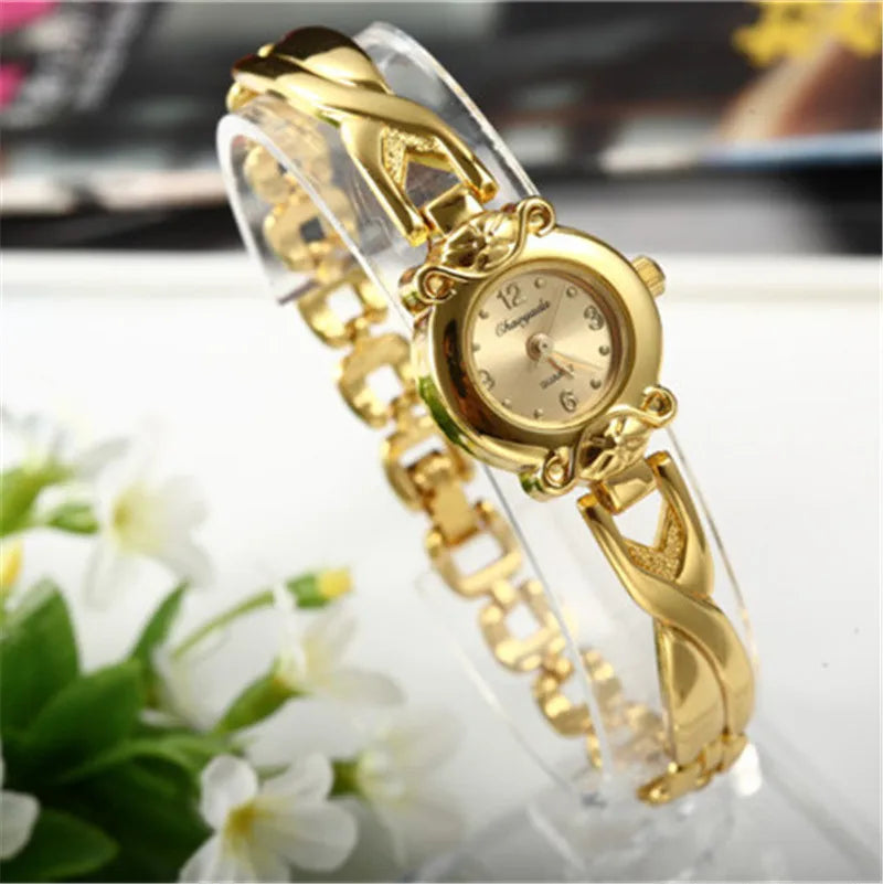 Gold-tone mesh bracelet watch worn on wrist