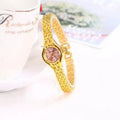 Gold-tone mesh bracelet watch dial close-up