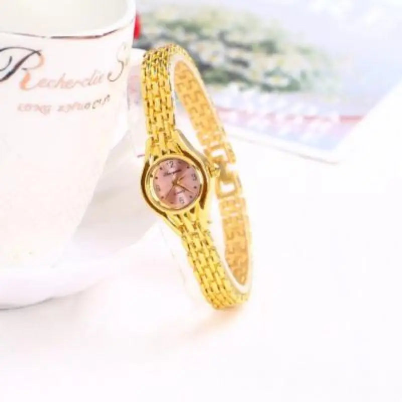 Gold-tone mesh bracelet watch dial close-up