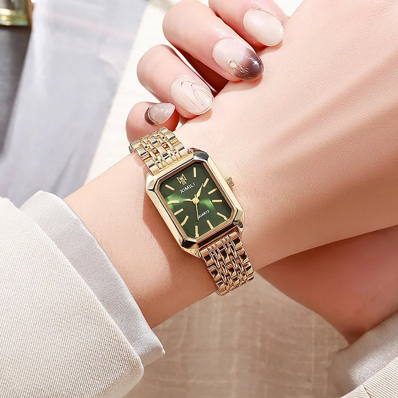 Gold-tone rectangle quartz watch, sunburst dial close-up