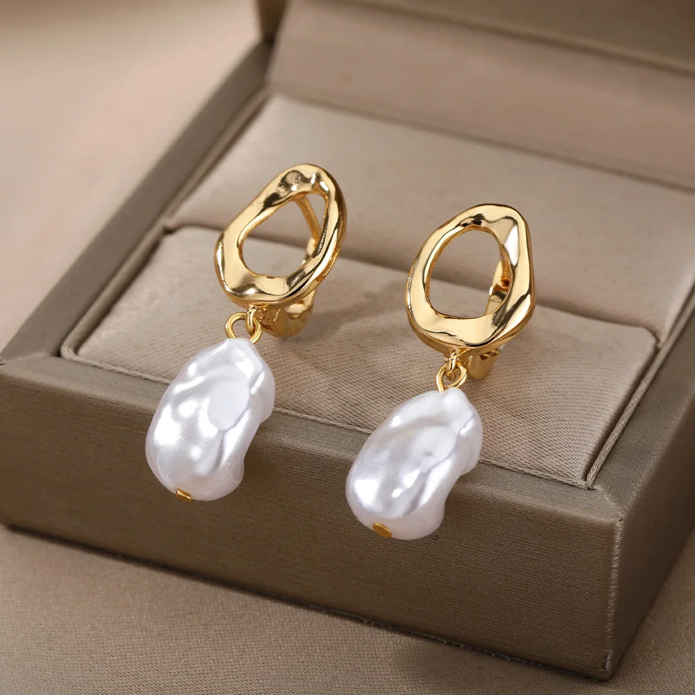 Heart hoop earrings in stainless steel with cubic zirconia heart accent, worn on model, close-up - Varex HQ