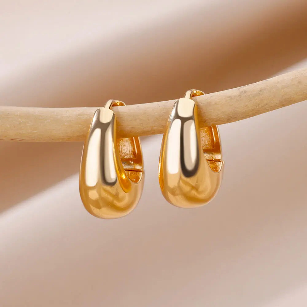 Heart hoop earrings in stainless steel with cubic zirconia heart accent, styling angle 1 - Varex HQ