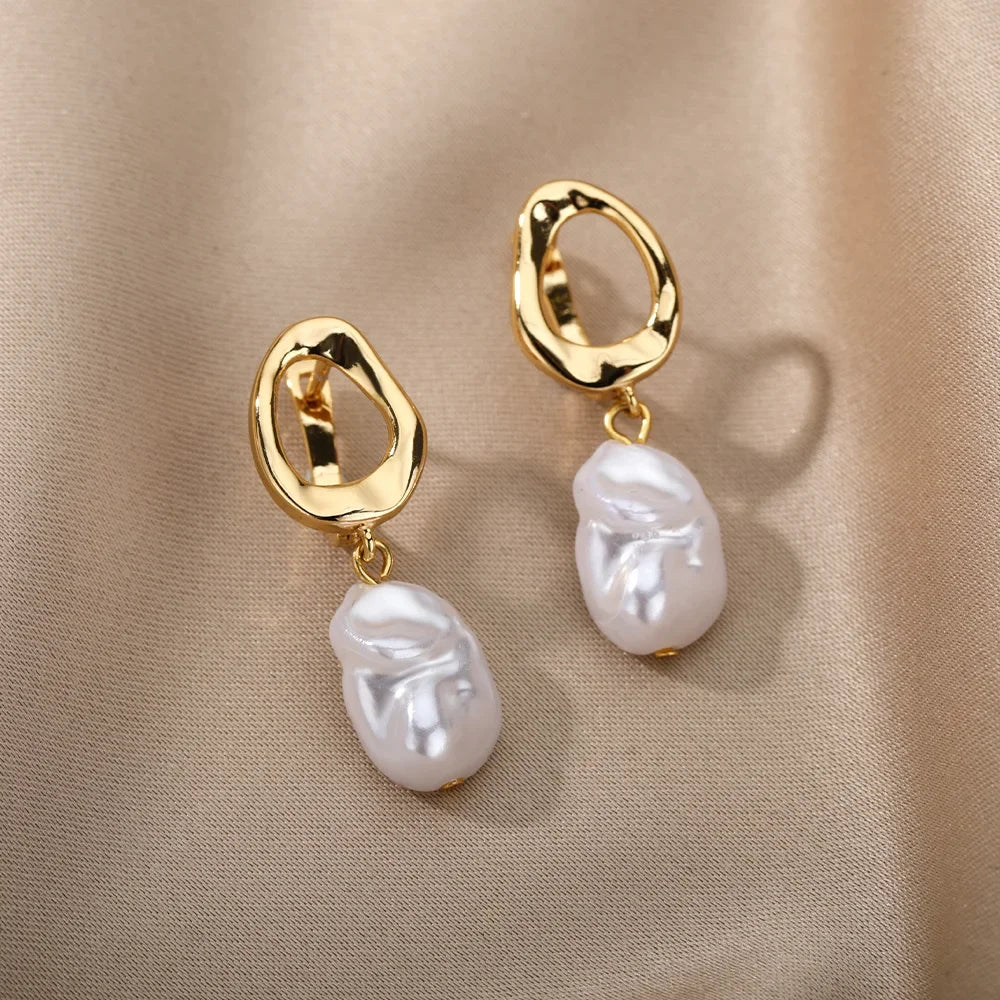 Heart hoop earrings in stainless steel with cubic zirconia heart accent, styling angle 12 - Varex HQ