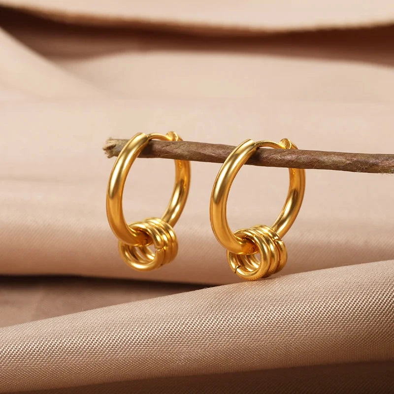 Heart hoop earrings in stainless steel with cubic zirconia heart accent, styling angle 16 - Varex HQ