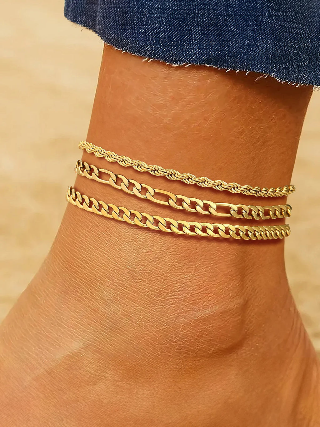 Layered chain anklet set gold-tone on model's ankle at the beach