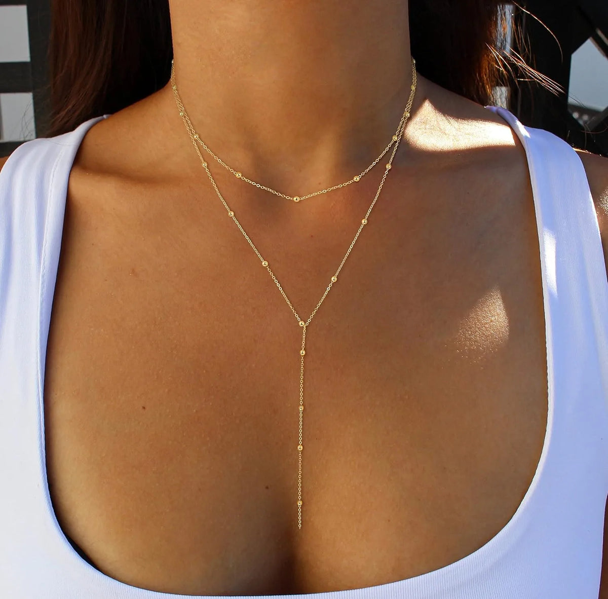 Layered Y-shape gold-plated pendant necklace with beaded chain drop - close-up detail - Varex HQ