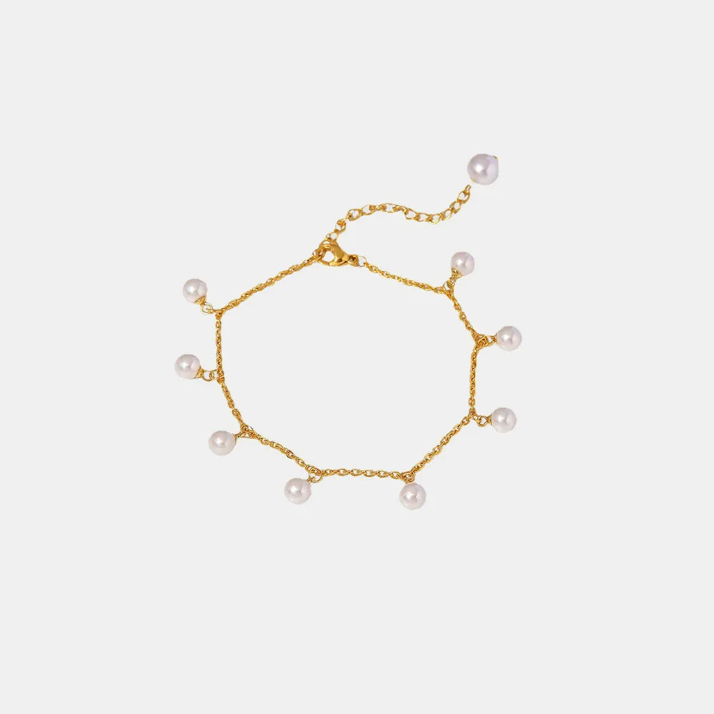 A clear, flat-lay studio product shot of the Lumina gold-plated pearl anklet against a pure white background - Varex HQ