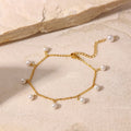 Lumina gold-plated stainless steel pearl charm anklet displayed on textured stone - Varex HQ luxury jewelry