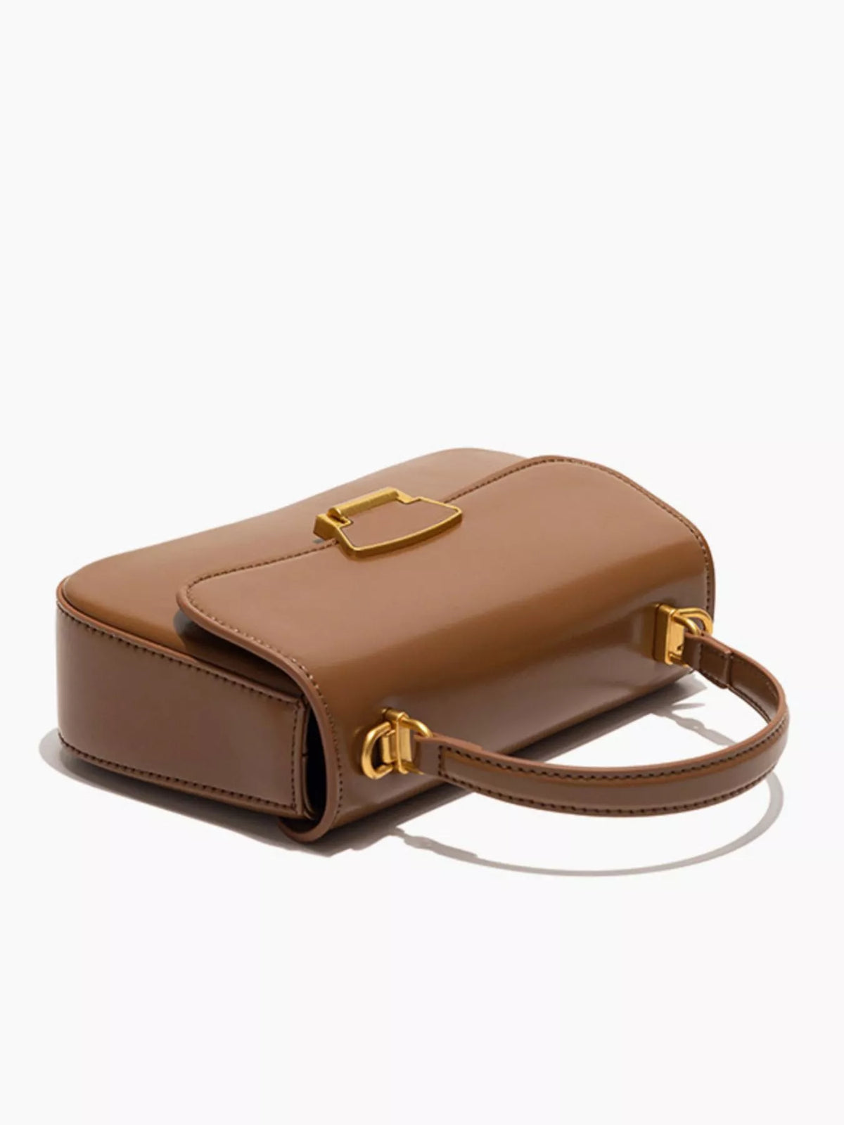 Mini vegan leather crossbody bag - close-up of polished gold-tone turn-lock clasp