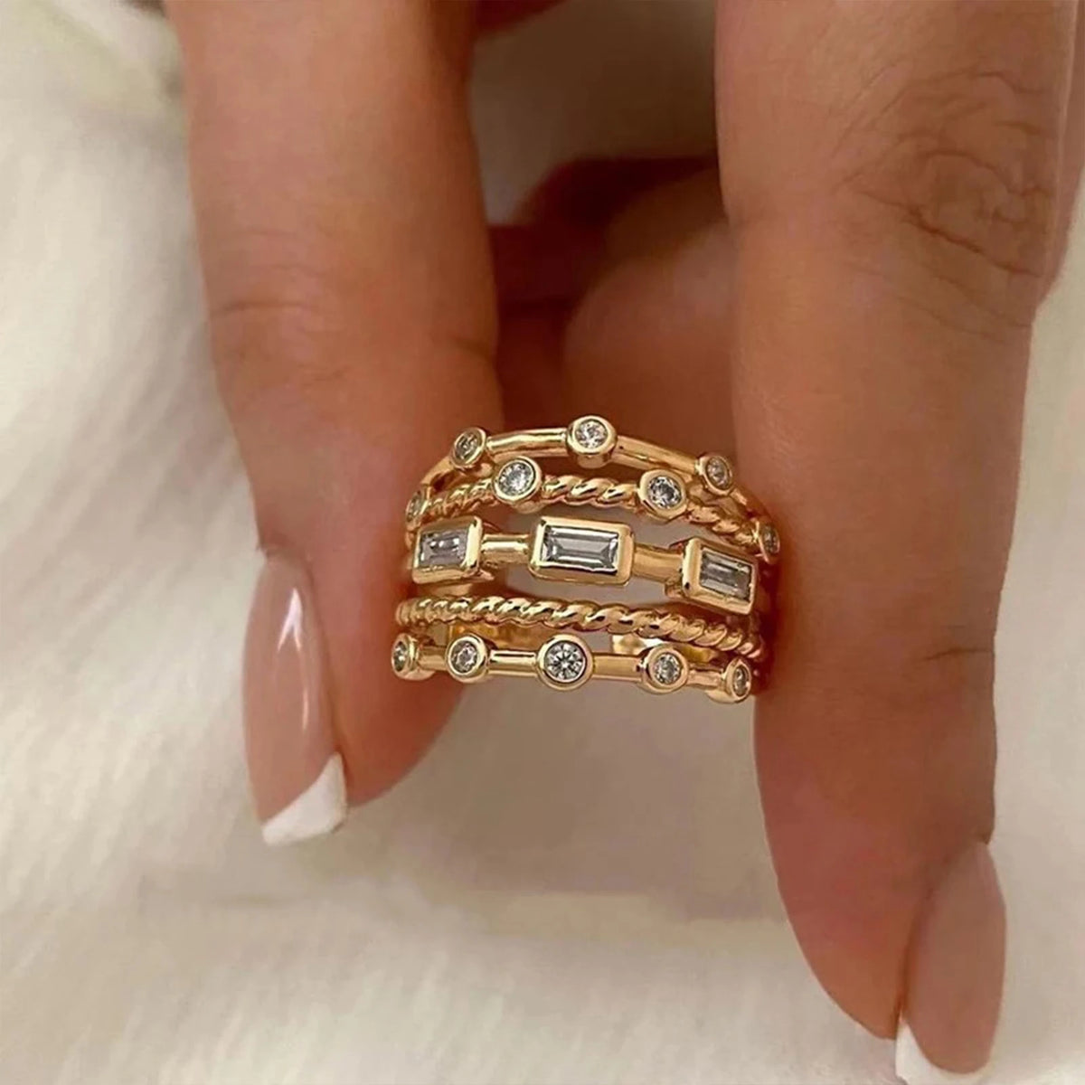 Angled view of gold-tone crystal ring catching light