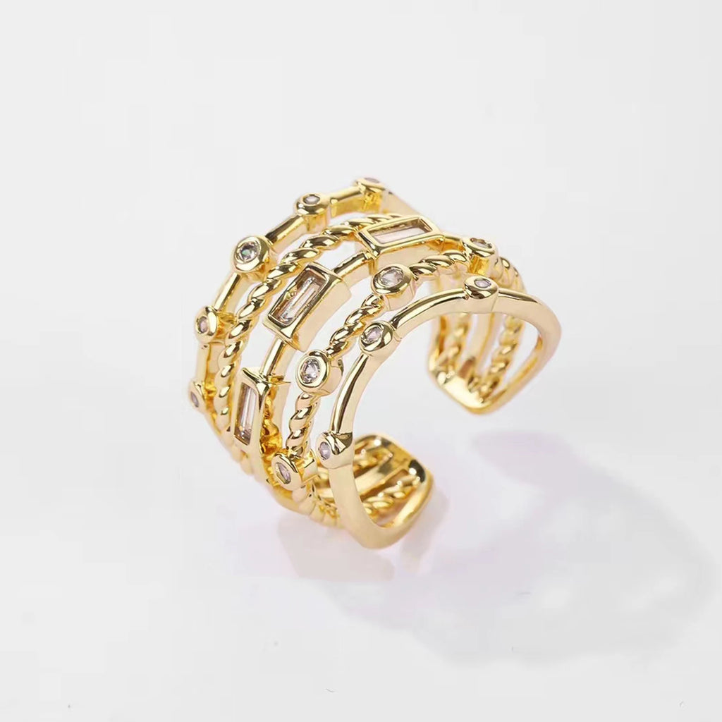 Multi-layer gold-tone crystal ring worn on finger