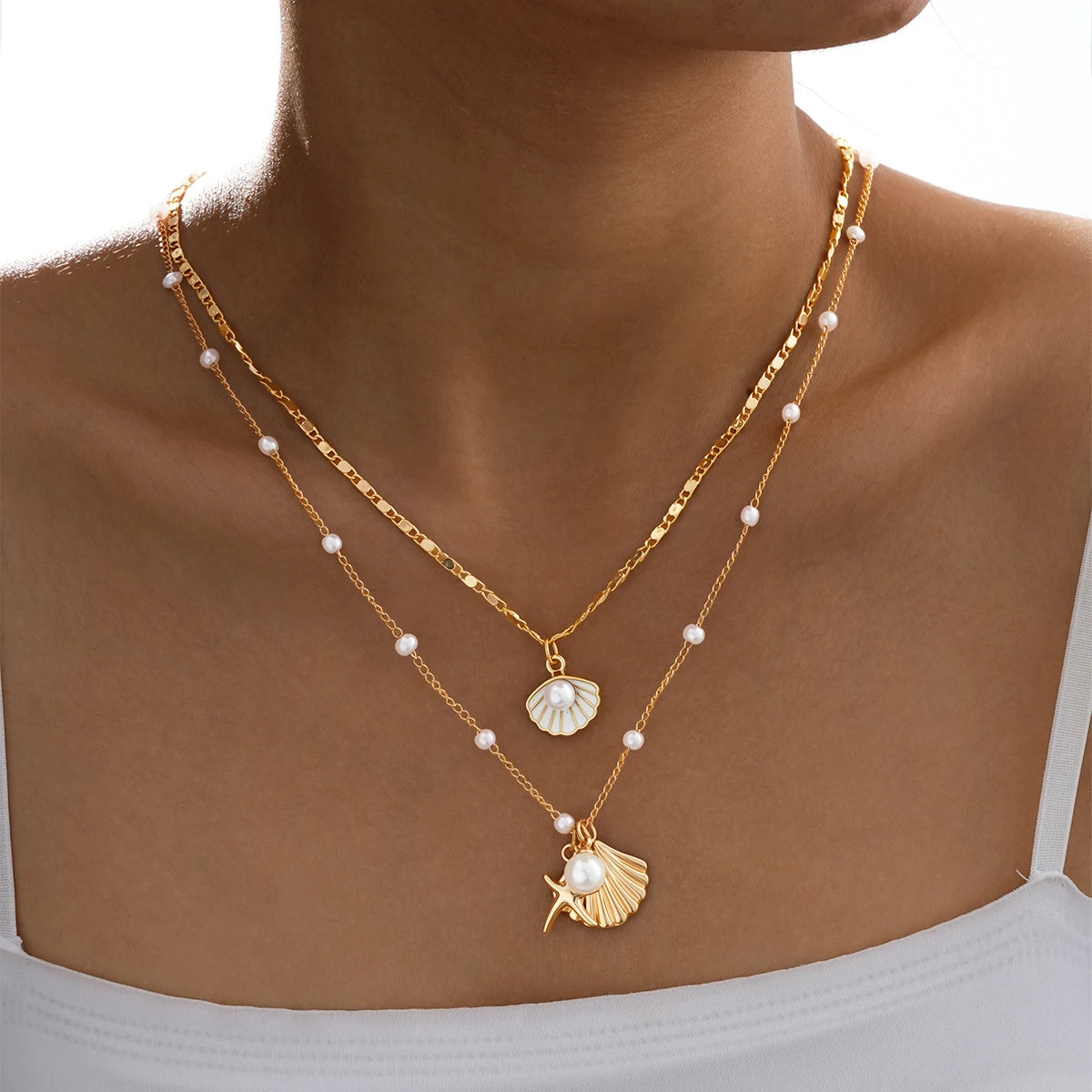 4-piece ocean charm layered necklace set in gold tones with shell, starfish, and pearl charms - alternate styling - Varex HQ