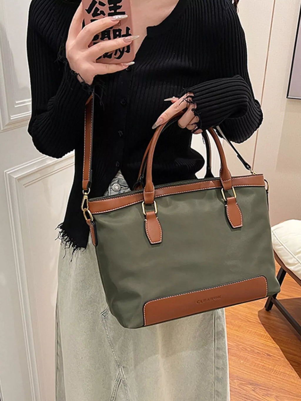 Olive green vegan leather tote bag - close-up of tan leather handles and gold-tone hardware