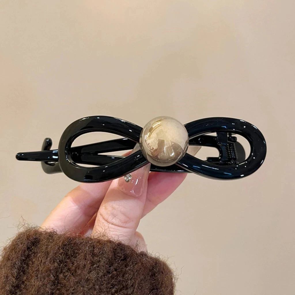 Pearl Mini Hair Claw Clip in acrylic with faux pearl accents, in hand for scale - Varex HQ