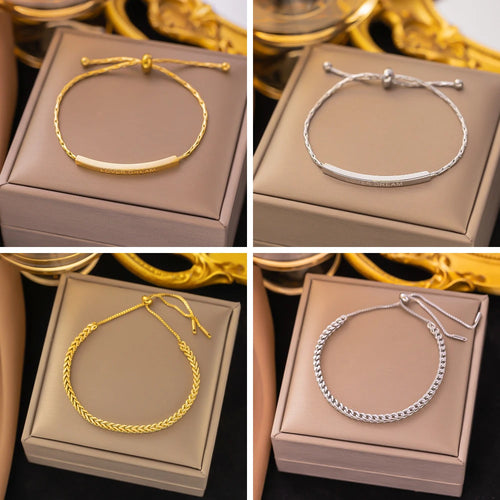 Adjustable pull-back bangle in gold-tone stainless steel, front view - Varex HQ