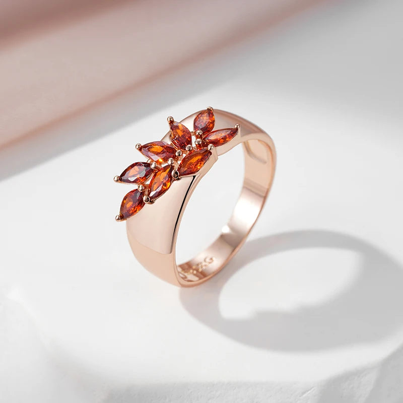 Rose gold-plated leaf ring with red zircon accent stone, front view